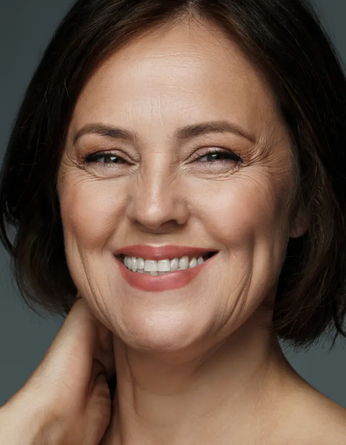 Close-up of aging lady whose skin is showing wrinkles, fine lines, and loss of elasticity due to collagen depletion.